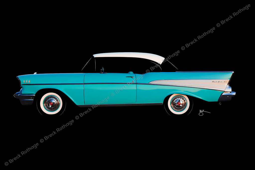 1957 Chevrolet Bel Air Sport Coup hardtop in India Ivory over Tropical Turquoise, complete with whitewall tires in iconic profile on black, metal canvas. The ultimate eye candy. Sixty-five years after its introduction in the U.S. automotive market, the ’57 Chevy Bel Air hardtop is prized by collectors worldwide.
