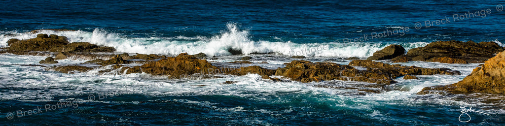 The view from one of the most exclusive coves on the California coast, Montage 262 captures the view from the famed Montage Luxury Hotel in Laguna Beach. White Sea spray is tossed above the rocks and tumbles back down as a powerful wave rolls in toward the shore. The deep blue and aqua of the Pacific Ocean are shown in all their splendor as sunlight beams back prisms of majestic saltwater. 